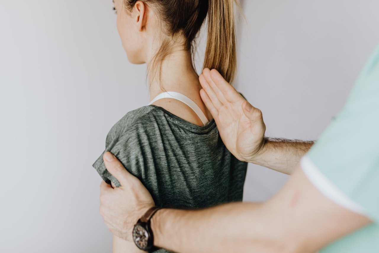 A female patients getting her back adjusted